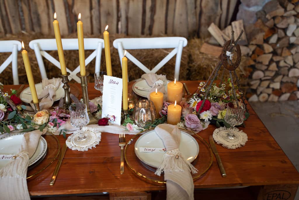 Tischdeko mit Blumen und gelben Kerzen