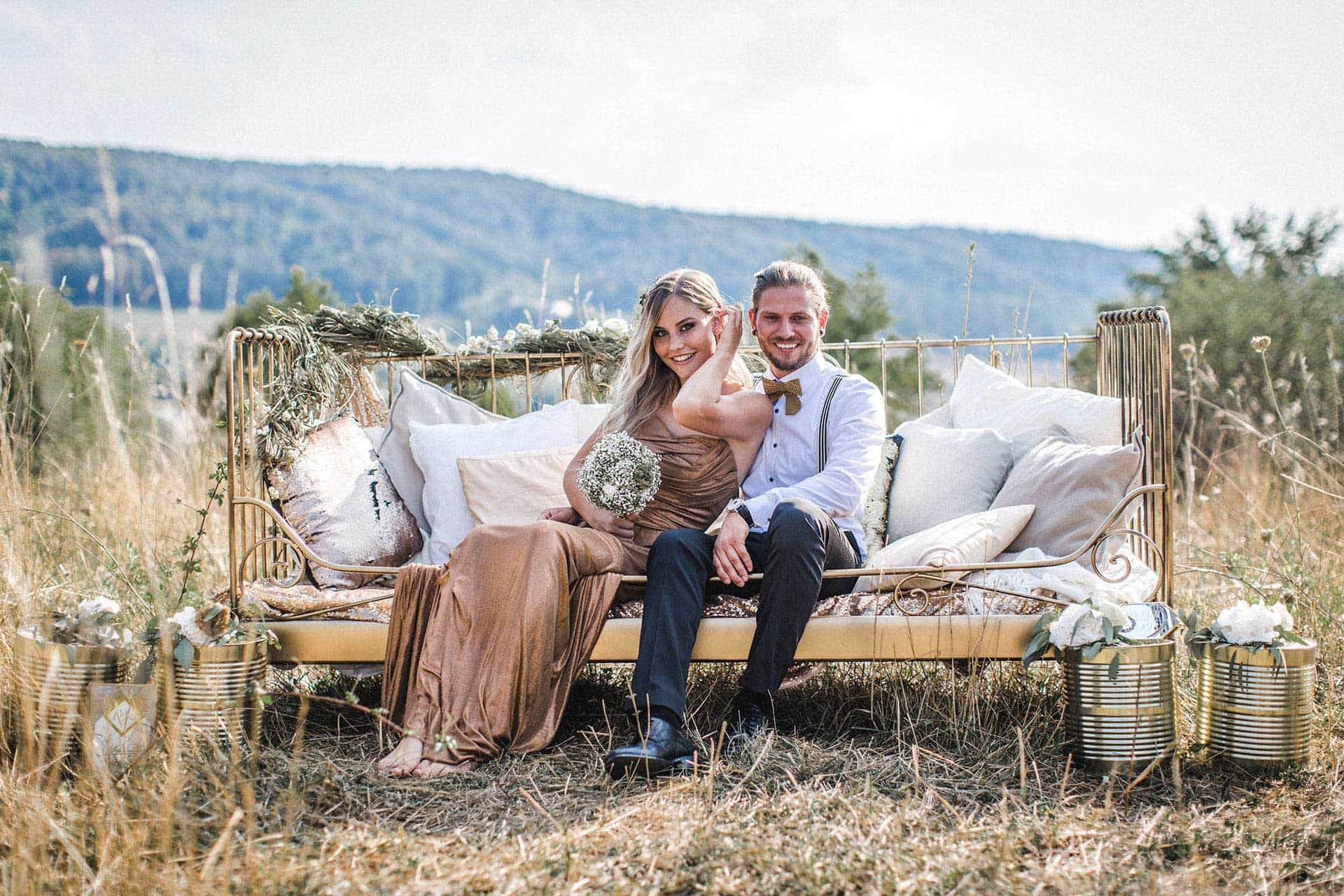 Mit Blumen geschmücktes Sofa zur Hochzeit mit Brautpaar